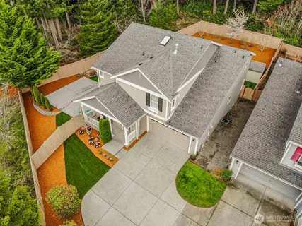 a front view of a house with a yard and a garage