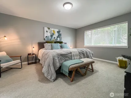 a bedroom with a bed and a couch