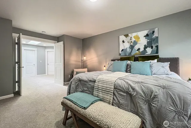 a bedroom with a bed and painting on the wall