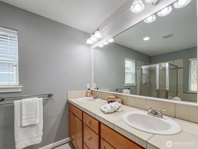a bathroom with a sink double vanity and a mirror