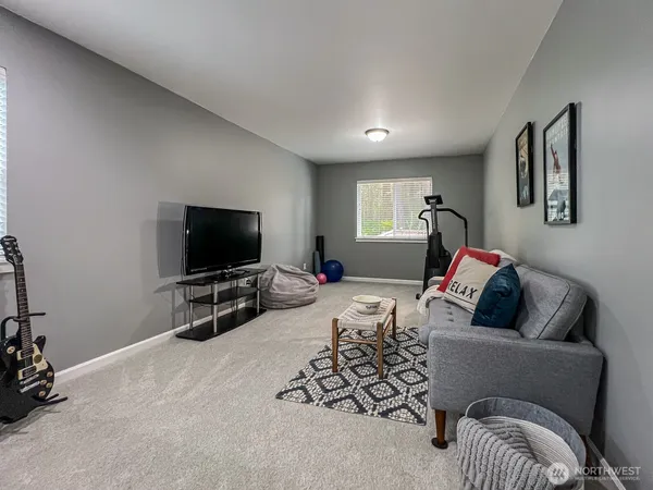 a bedroom with furniture and a flat screen tv