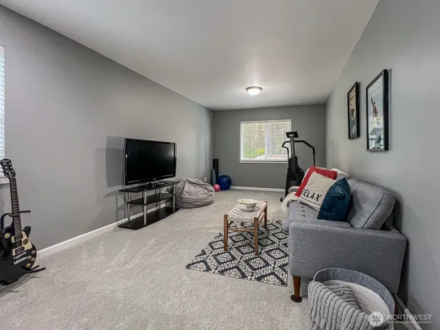 a bedroom with furniture and a flat screen tv