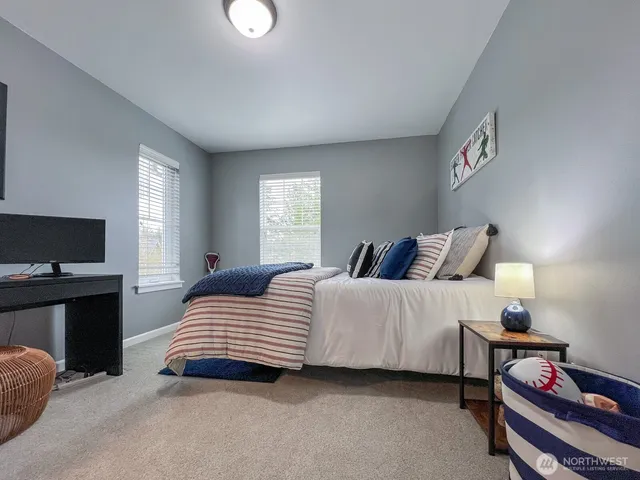 a bedroom with a bed and a television