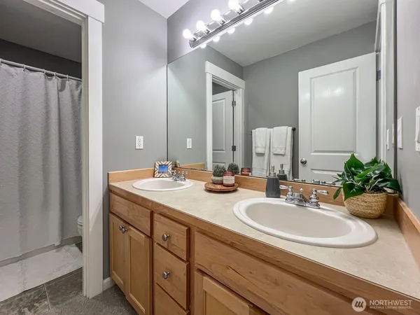 a bathroom with double vanity sinks and a mirror