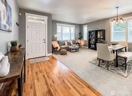 a living room with furniture fireplace and window