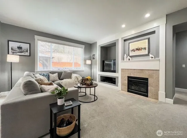 a living room with furniture and a fireplace