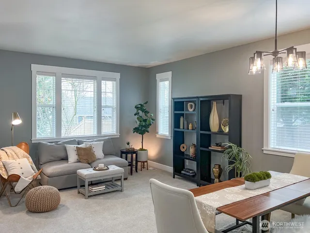 a living room with furniture a chandelier and a window
