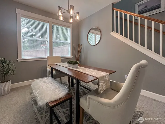 a view of a dining room with furniture and window