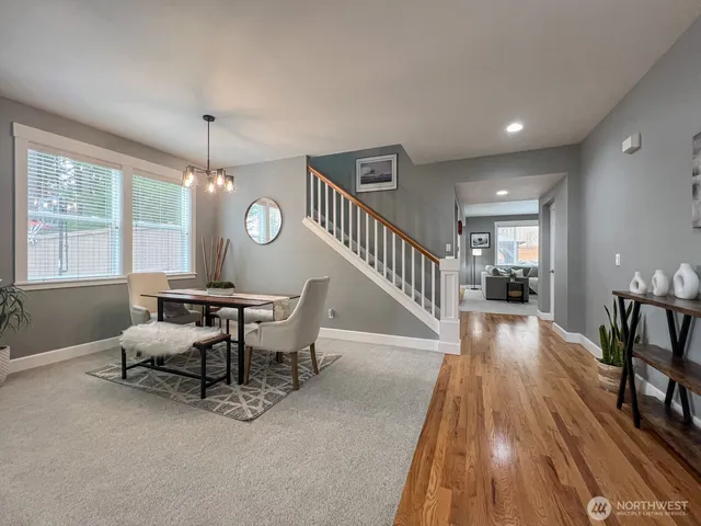 a view of a livingroom with furniture wooden floor and windows