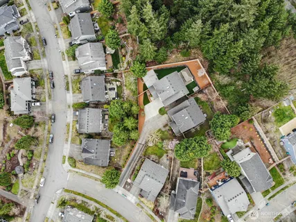 an aerial view of a house with a yard
