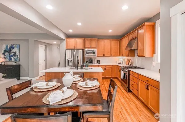 a large kitchen with a table and chairs