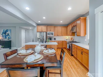 a kitchen with a stove and a white table