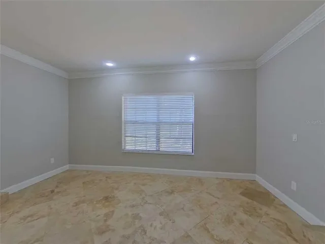 a view of an empty room and a window