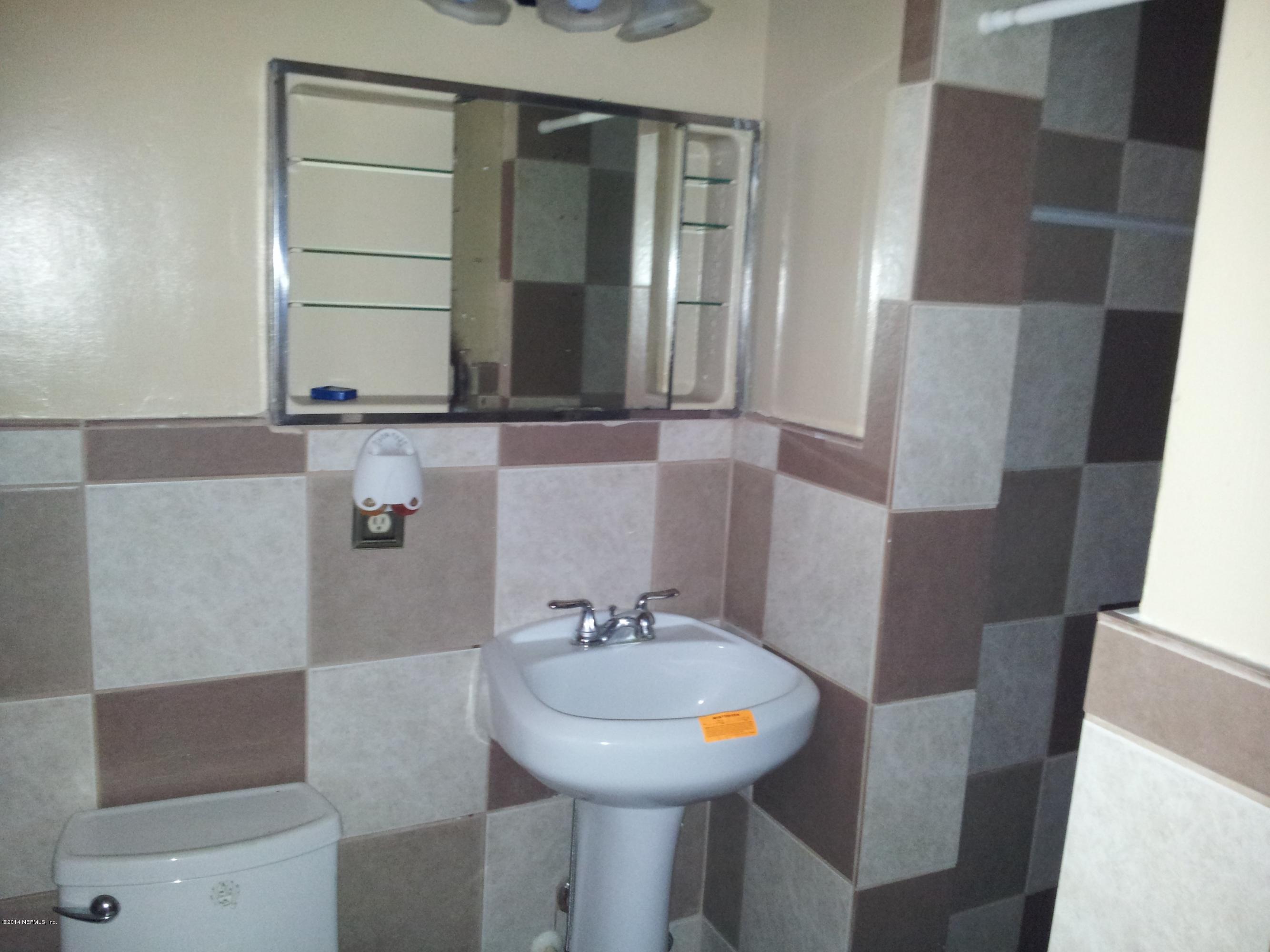 6542 Colgate Road Jacksonville, FL 32217 - Photo 3 of 9 a bathroom with a sink and a mirror