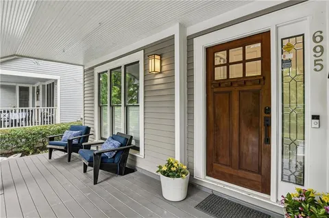 a balcony with furniture and wooden floor