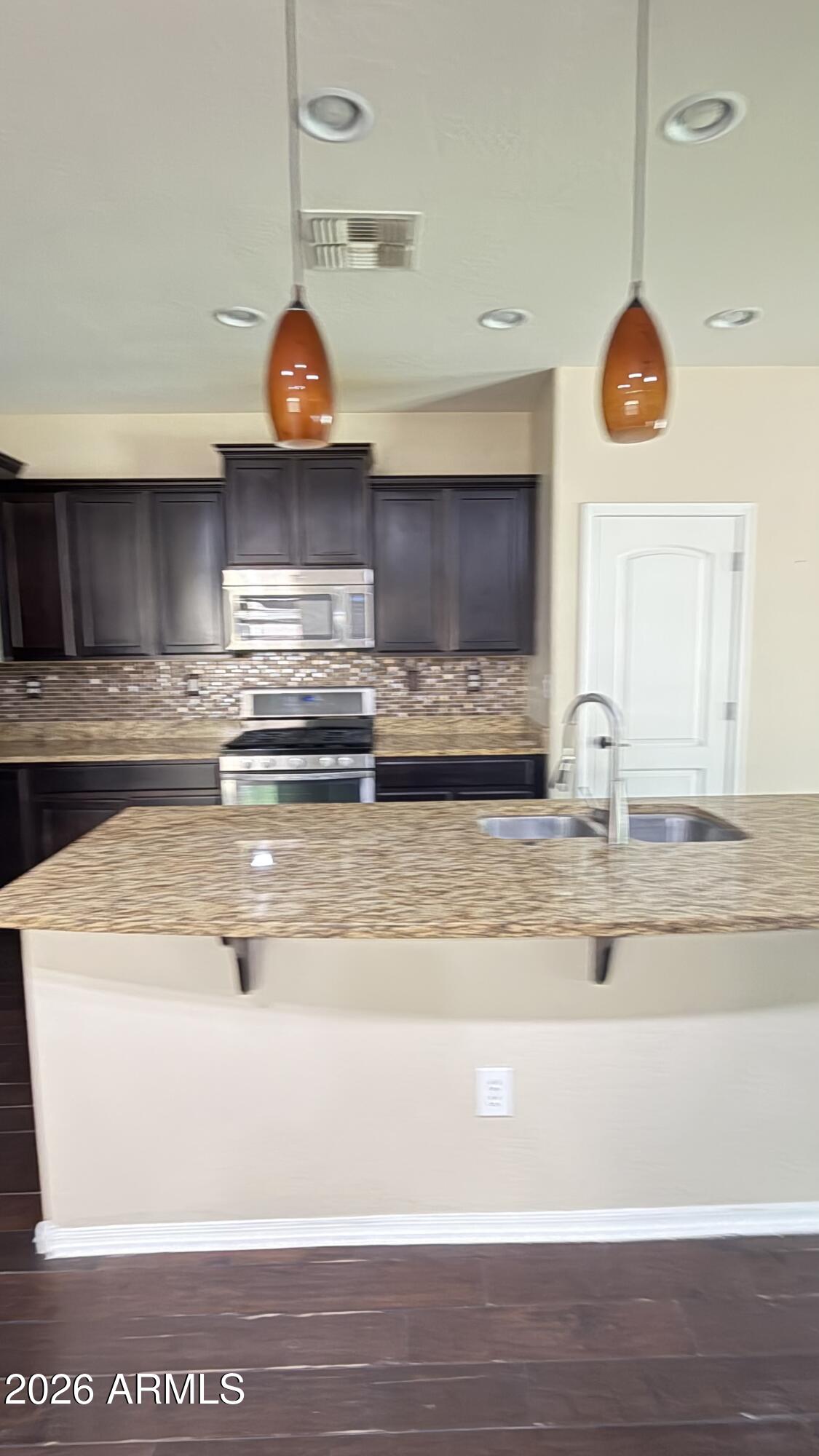 10786 West Yearling Road Peoria, AZ 85383 - Photo 4 of 21 a view of a kitchen counter top and stove