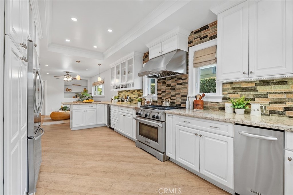 1015 Nottingham Road Newport Beach, CA 92660 - Photo 11 of 34 a kitchen with white cabinets and white appliances