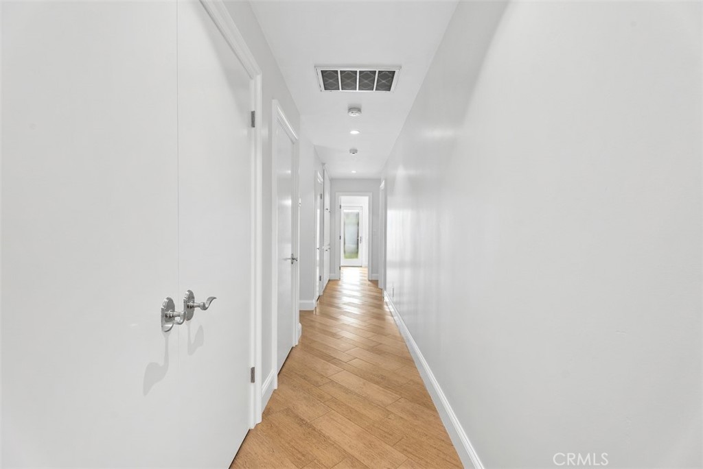 1015 Nottingham Road Newport Beach, CA 92660 - Photo 19 of 34 a view of a hallway with wooden floor and staircase
