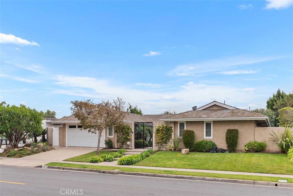 1015 Nottingham Road Newport Beach, CA 92660 - Photo 2 of 34 a front view of a house with a garden