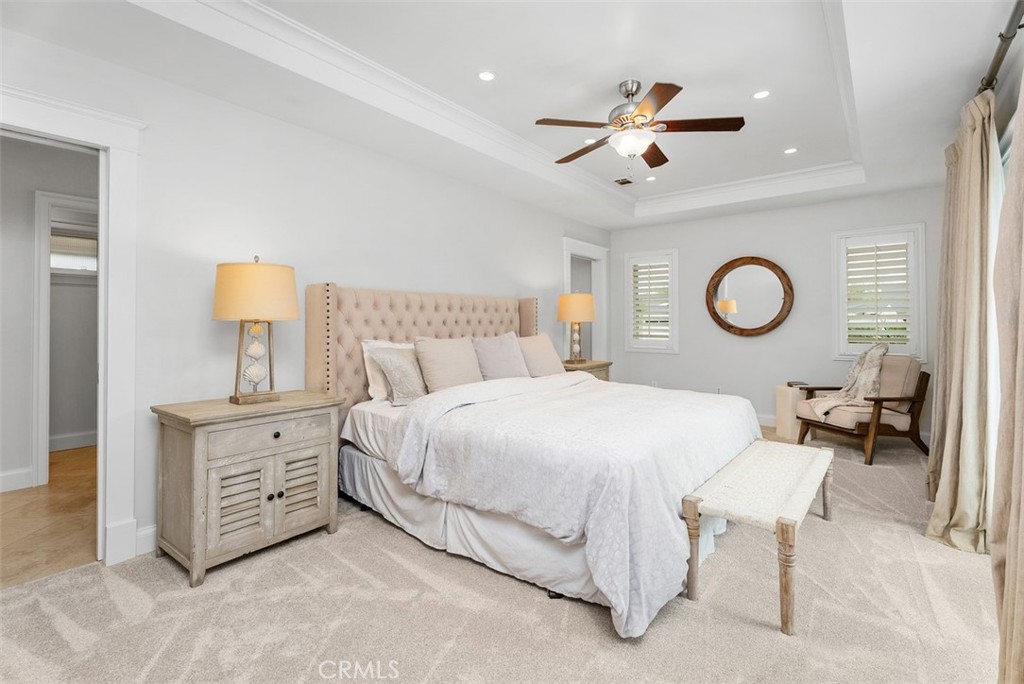 1015 Nottingham Road Newport Beach, CA 92660 - Photo 23 of 34 a spacious bedroom with a bed and a chandelier