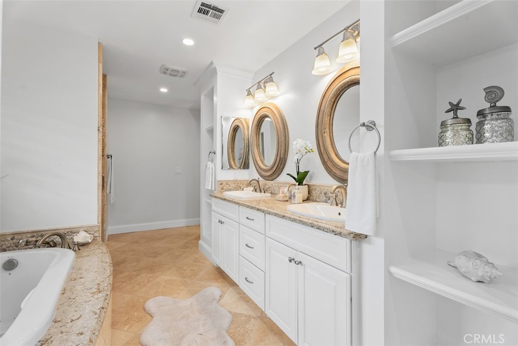 1015 Nottingham Road Newport Beach, CA 92660 - Photo 25 of 34 a bathroom with a granite countertop sink and a mirror