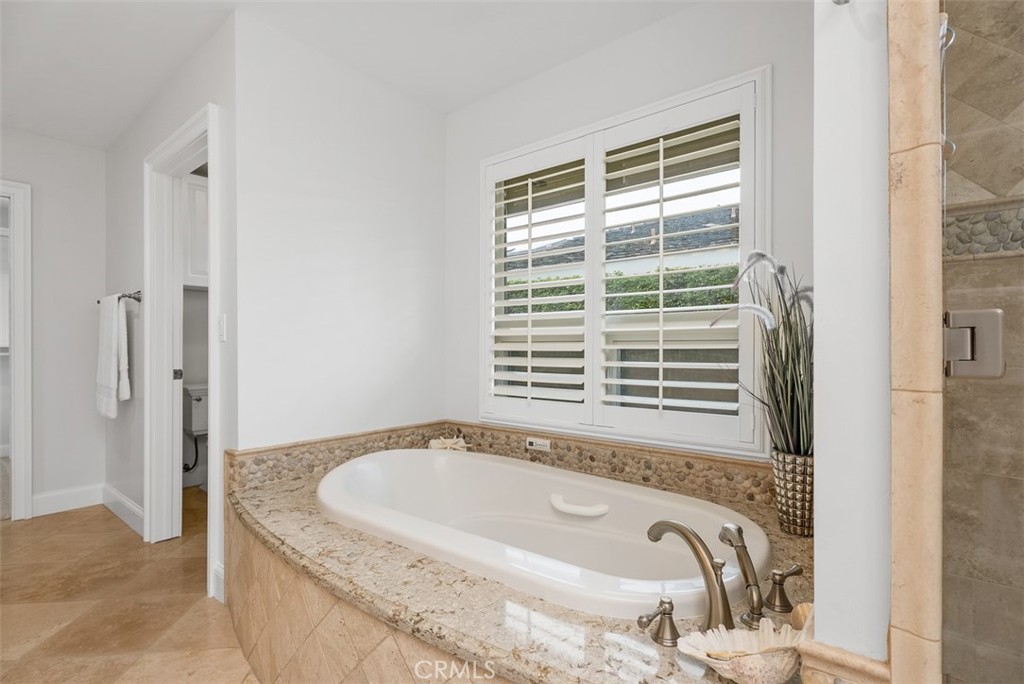 1015 Nottingham Road Newport Beach, CA 92660 - Photo 27 of 34 a bath tub sitting in a bathroom next to a window