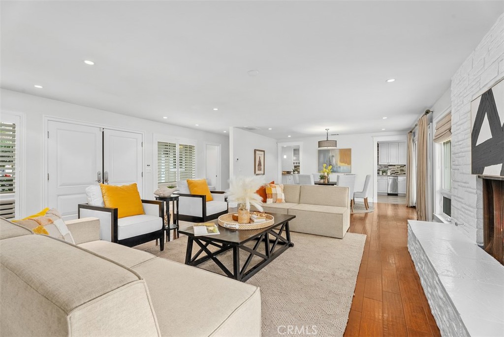 1015 Nottingham Road Newport Beach, CA 92660 - Photo 9 of 34 a living room with furniture a table and a flat screen tv