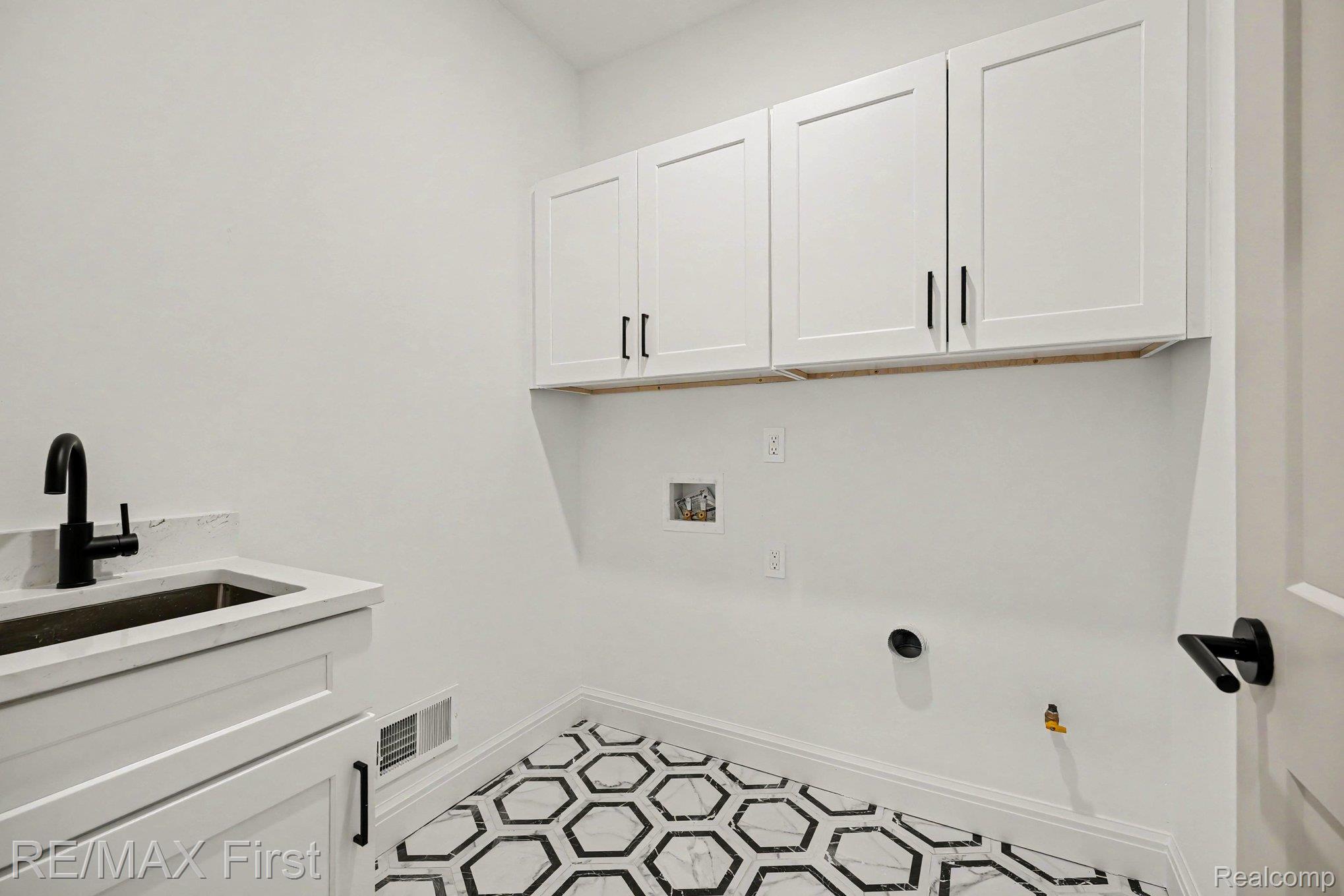 7424 Dyke Road Algonac, MI 48001 - Photo 19 of 31 Laundry room with cabinet space, hookup for a washing machine, and hookup for a gas dryer