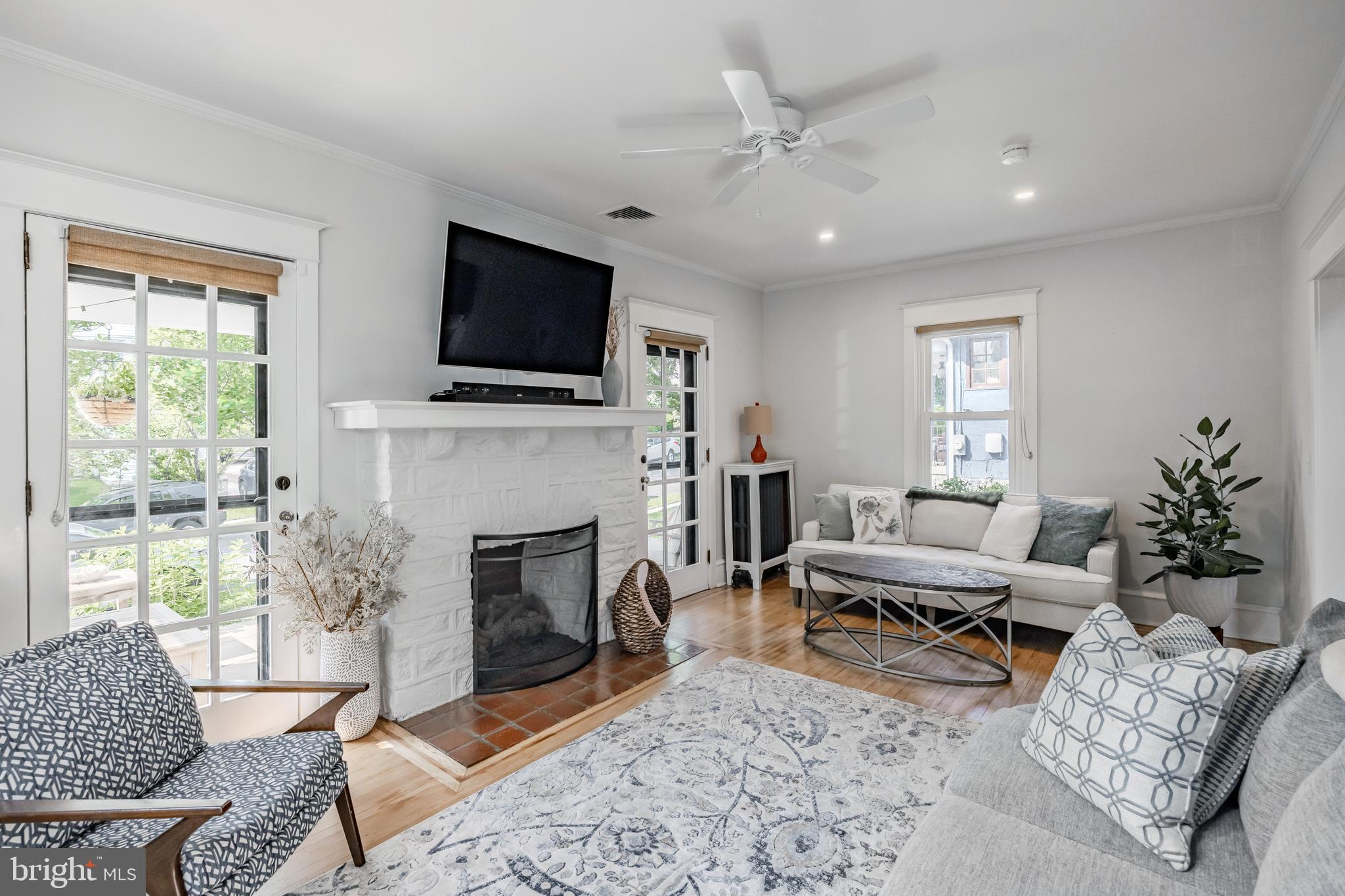 536 Kathmere Road Havertown, PA 19083 - Photo 11 of 45 a living room with furniture a flat screen tv and a fireplace