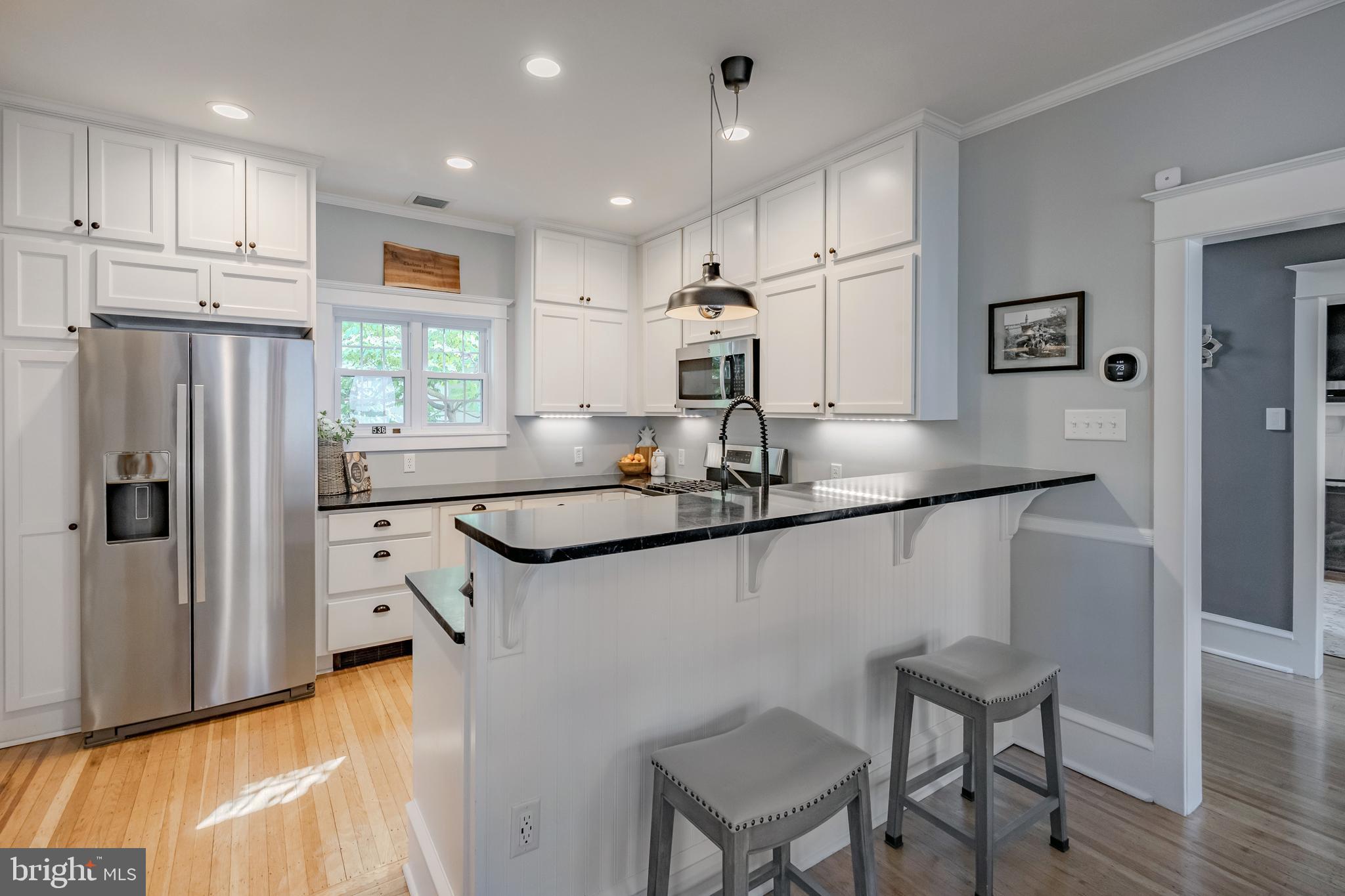 536 Kathmere Road Havertown, PA 19083 - Photo 19 of 45 a kitchen with kitchen island a counter top space cabinets and stainless steel appliances
