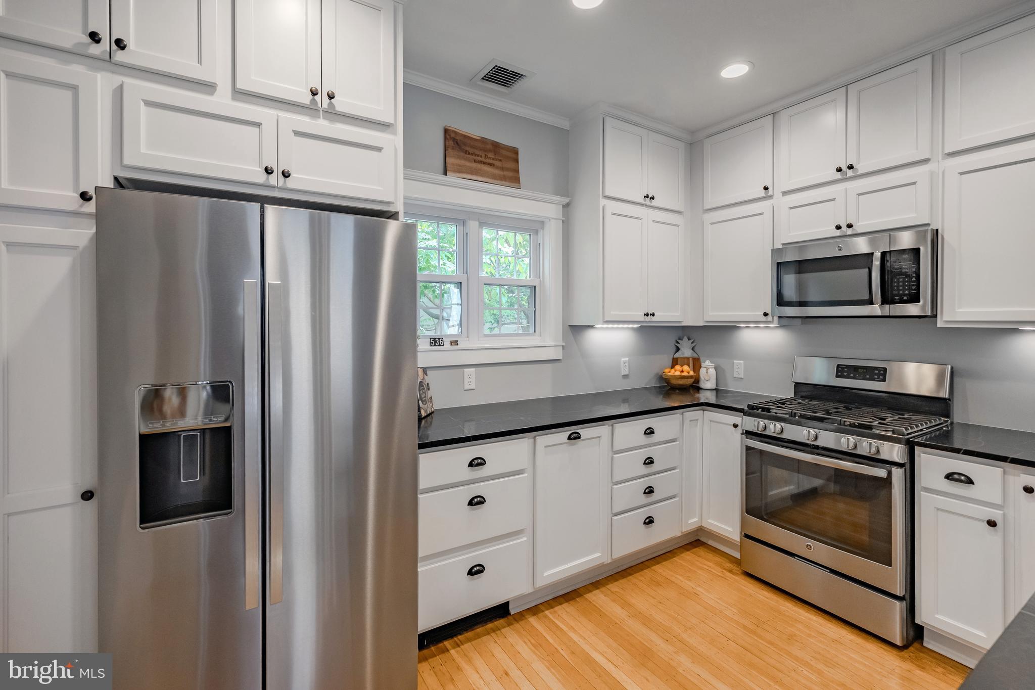 536 Kathmere Road Havertown, PA 19083 - Photo 20 of 45 a kitchen with stainless steel appliances white cabinets a stove a sink and a refrigerator