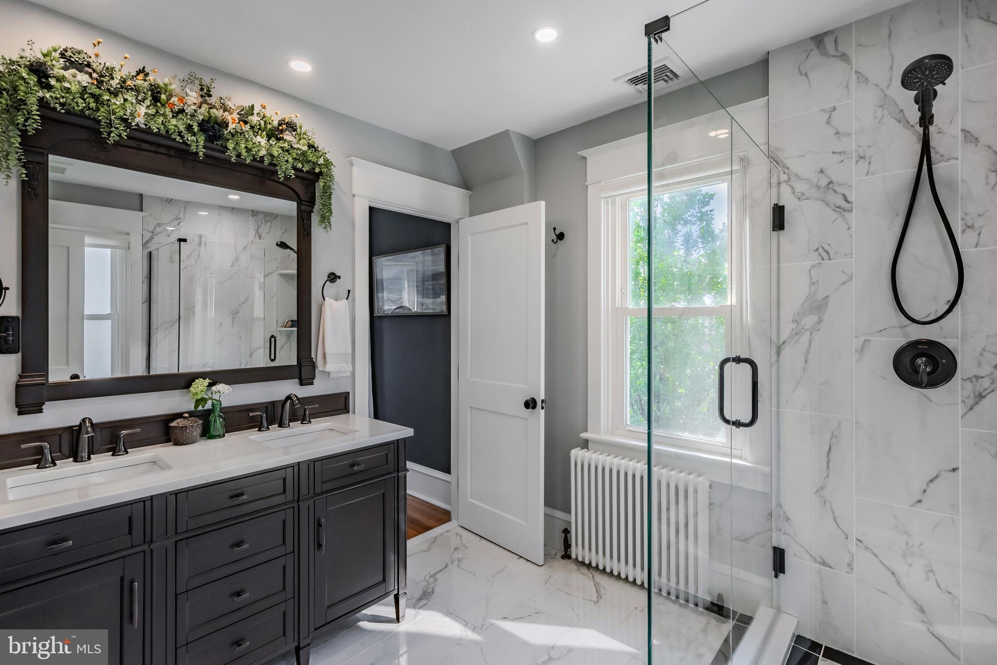 536 Kathmere Road Havertown, PA 19083 - Photo 29 of 45 a bathroom with a granite countertop sink a mirror a vanity and shower