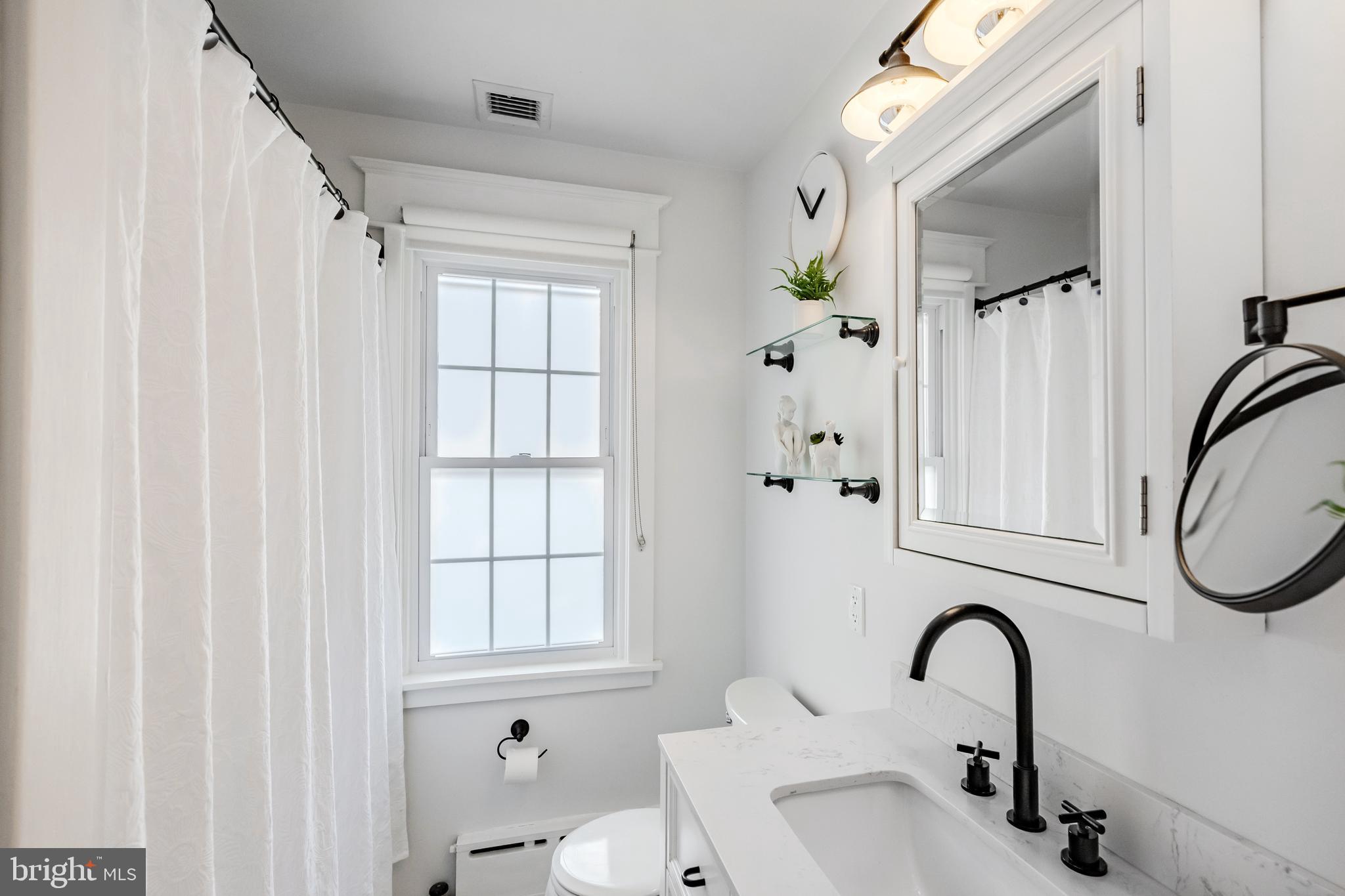 536 Kathmere Road Havertown, PA 19083 - Photo 36 of 45 a bathroom with a sink and a mirror