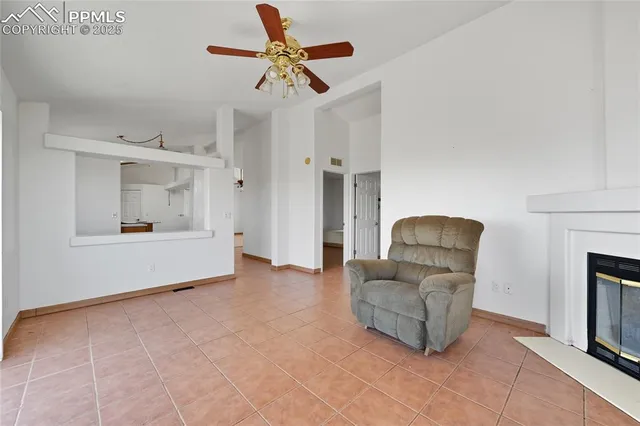a living room with furniture and a ceiling fan