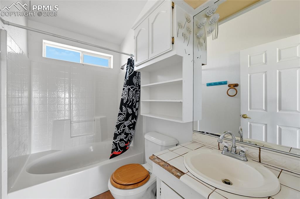 16595 Yoder Road Calhan, CO 80808 - Photo 21 of 28 a bathroom with a sink a toilet and shower