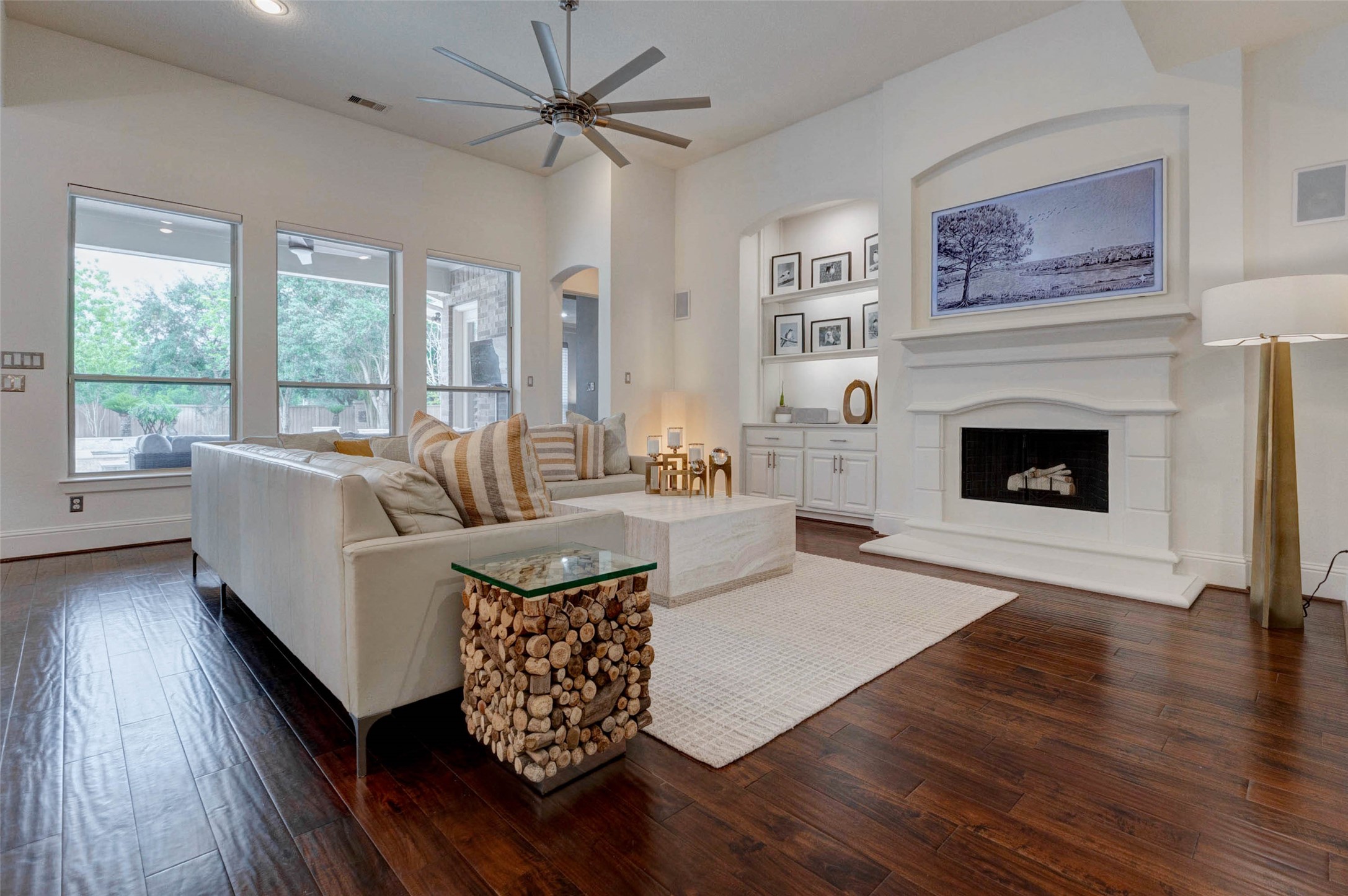 27602 Guthrie Ridge Lane Katy, TX 77494 - Photo 12 of 50 The elegant stone fireplace focal point is complemented by custom cabinetry and refined neutral finishes. The 65” Samsung Frame TV is included; seamlessly doubling as curated artwork to elevate the living space.