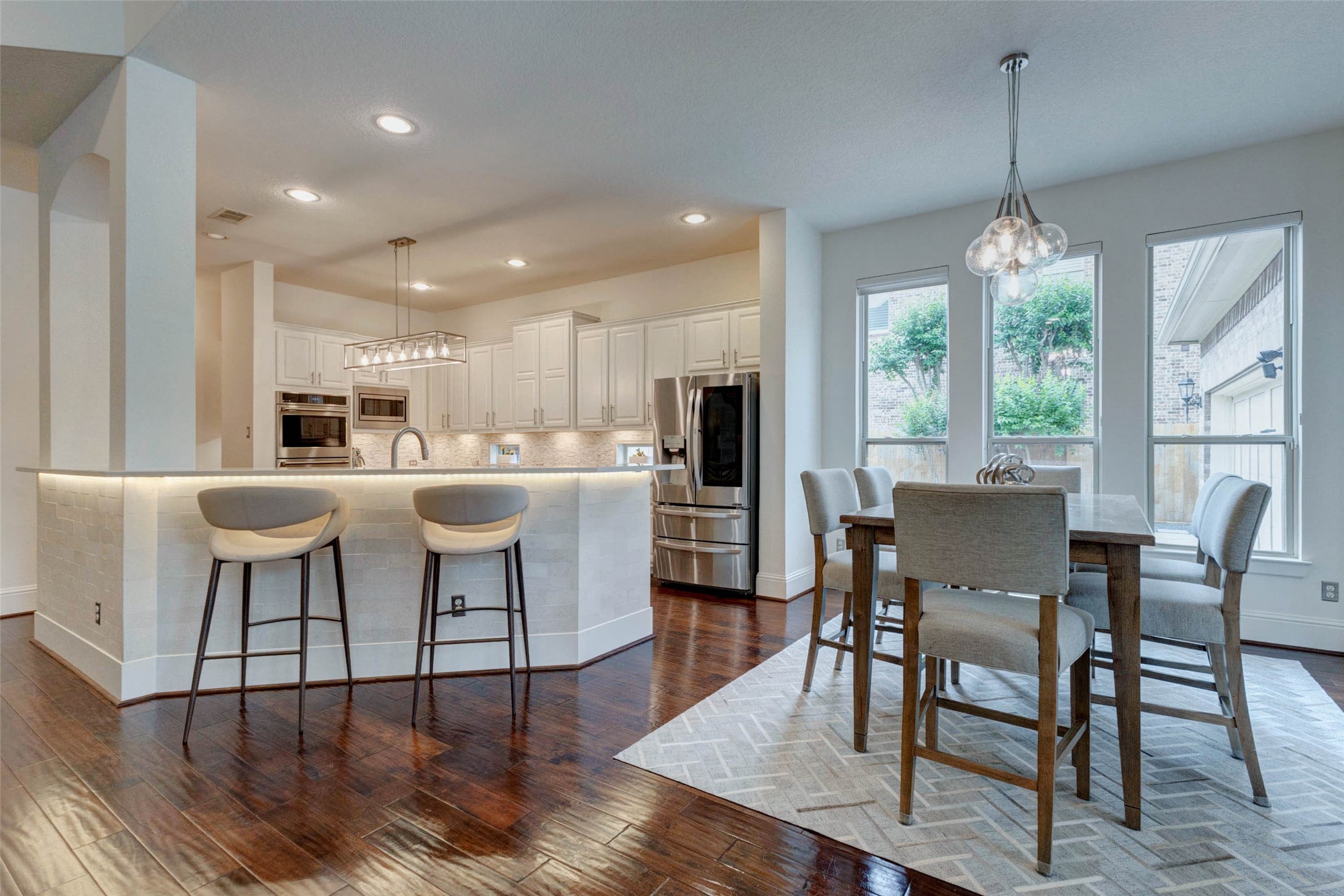 27602 Guthrie Ridge Lane Katy, TX 77494 - Photo 13 of 50 Bright kitchen with expansive bar seating, under-cabinet lighting, and effortless connection to dining
space.