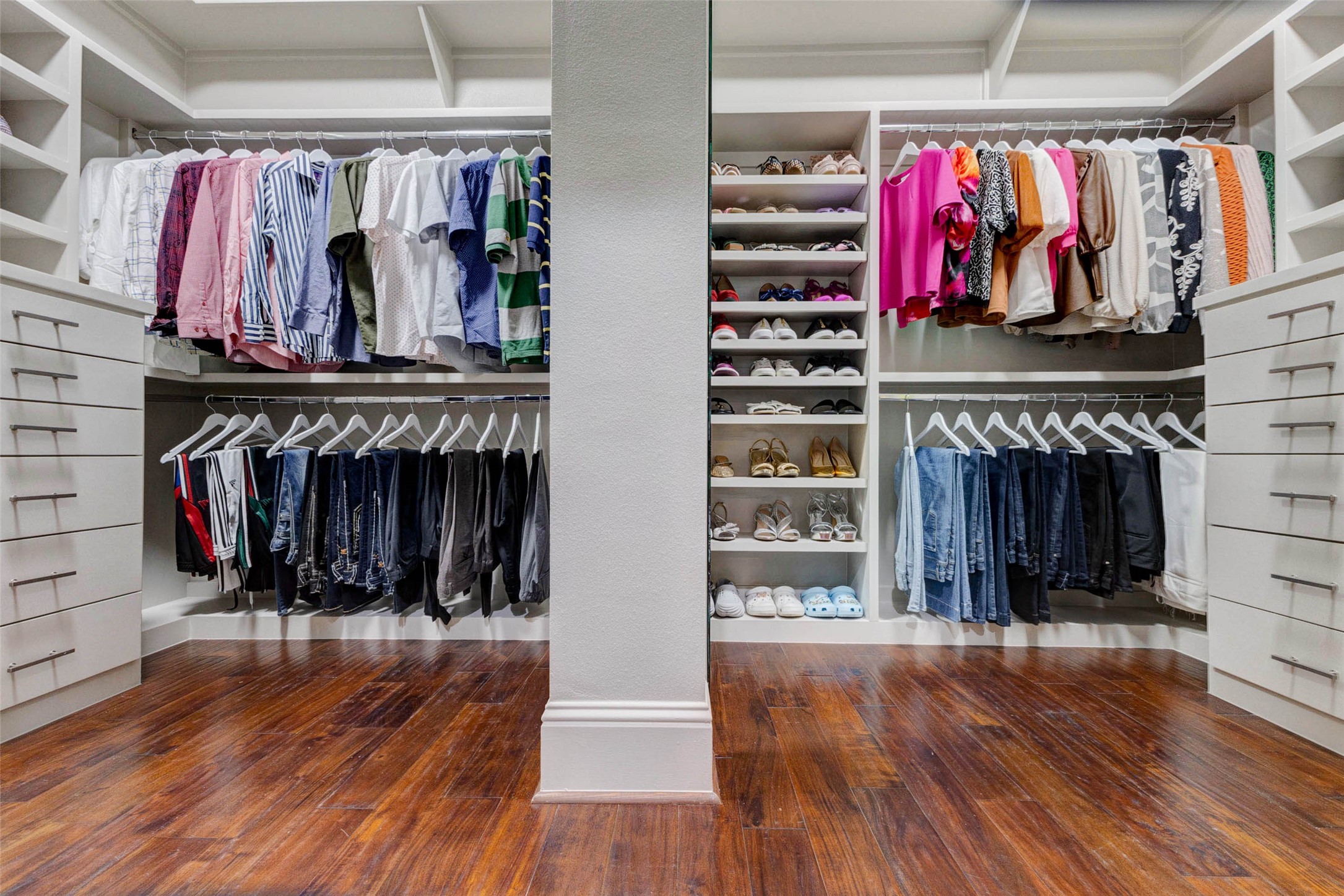 27602 Guthrie Ridge Lane Katy, TX 77494 - Photo 25 of 50 A well-designed custom dual wardrobe layout maximizes organization and accessibility, complemented by a large mirror on the right side not visible in this image.