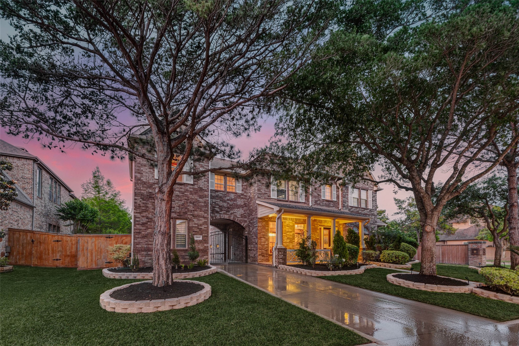 27602 Guthrie Ridge Lane Katy, TX 77494 - Photo 3 of 50 At twilight, the home transforms with a beautifully illuminated façade, creating a warm, inviting curb appeal.