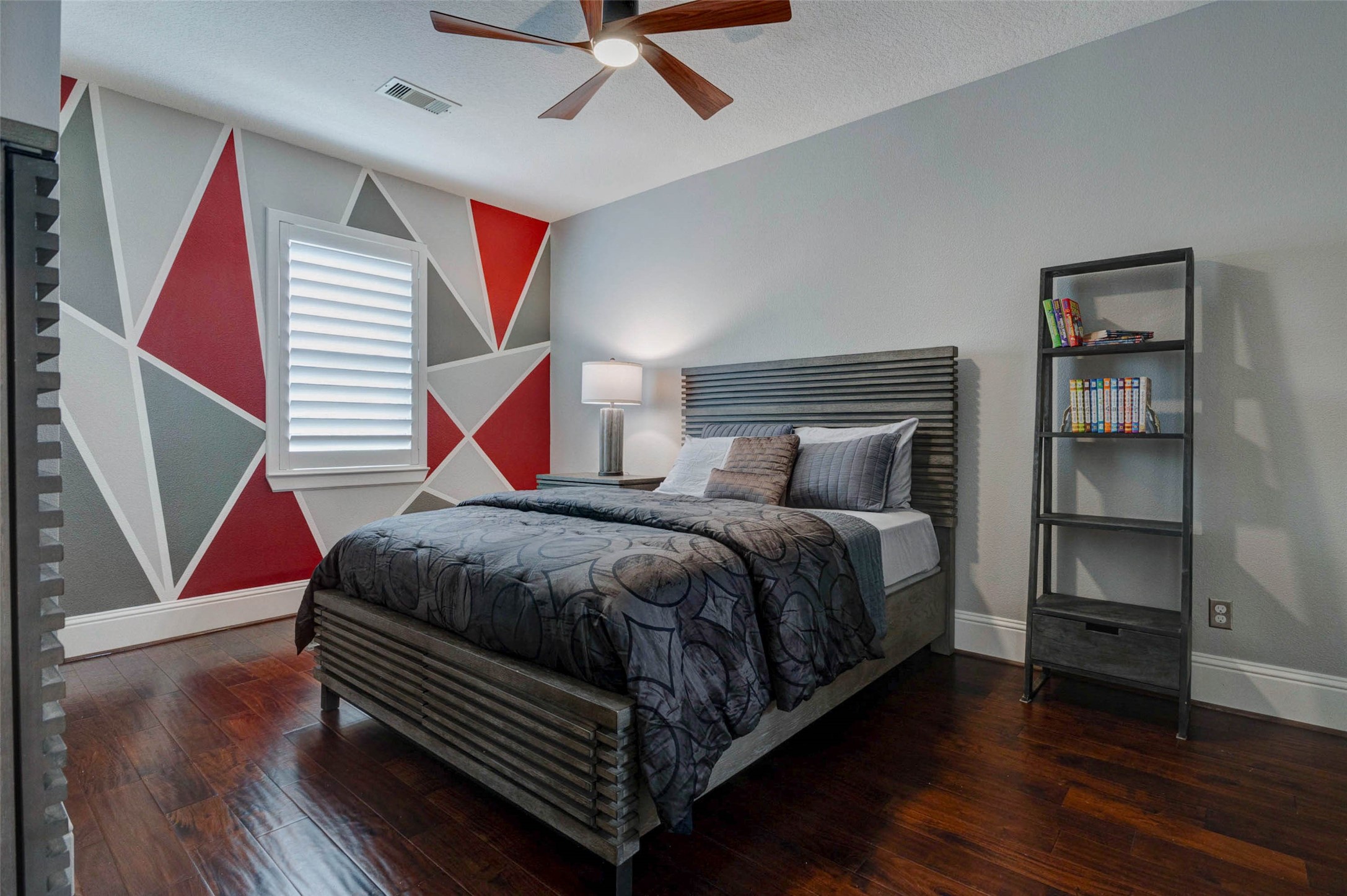 27602 Guthrie Ridge Lane Katy, TX 77494 - Photo 36 of 50 A thoughtfully designed contemporary secondary bedroom#3 with a bold custom accent wall creates a striking yet comfortable retreat with refined finishes.