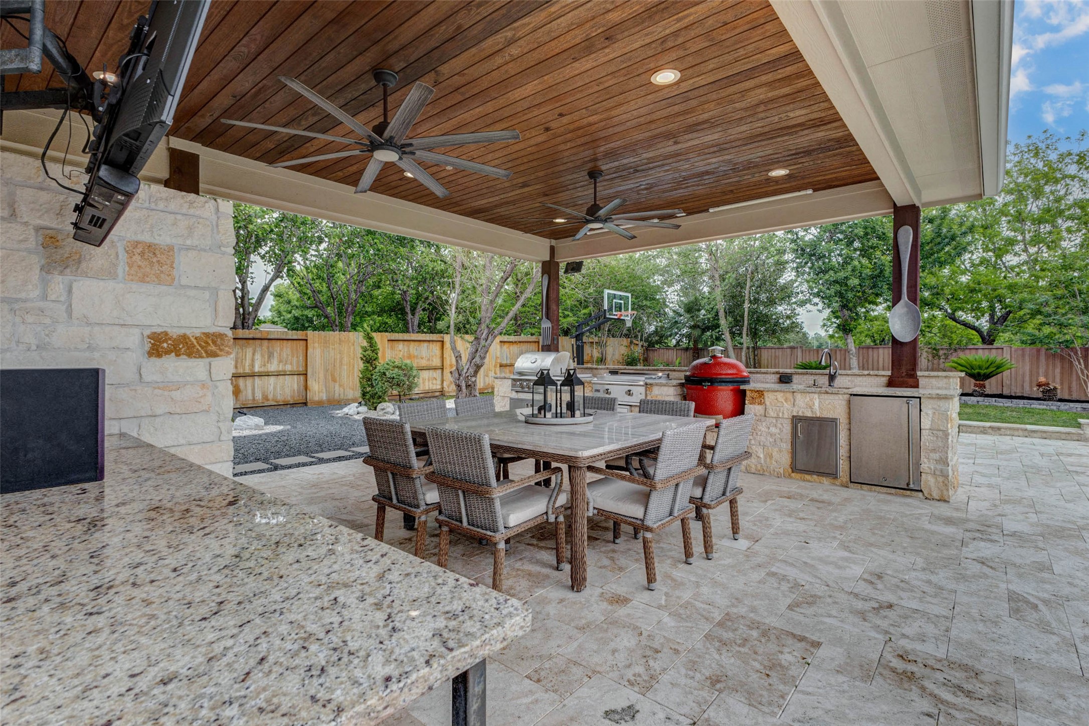 27602 Guthrie Ridge Lane Katy, TX 77494 - Photo 43 of 50 Another view highlights the covered entertaining space complemented by thoughtfully designed stone garden, adding texture and a serene, low-maintenance landscape element.