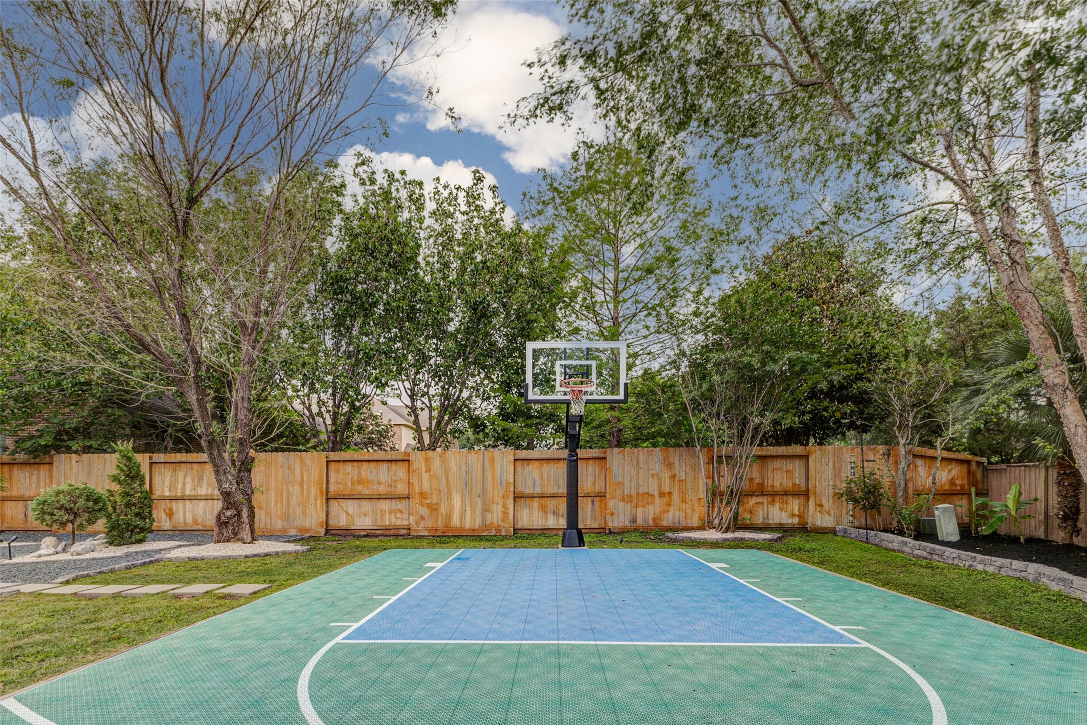 27602 Guthrie Ridge Lane Katy, TX 77494 - Photo 45 of 50 Tucked within the landscaped backyard, the private sport court provides a versatile space for basketball, recreation, and outdoor activity.