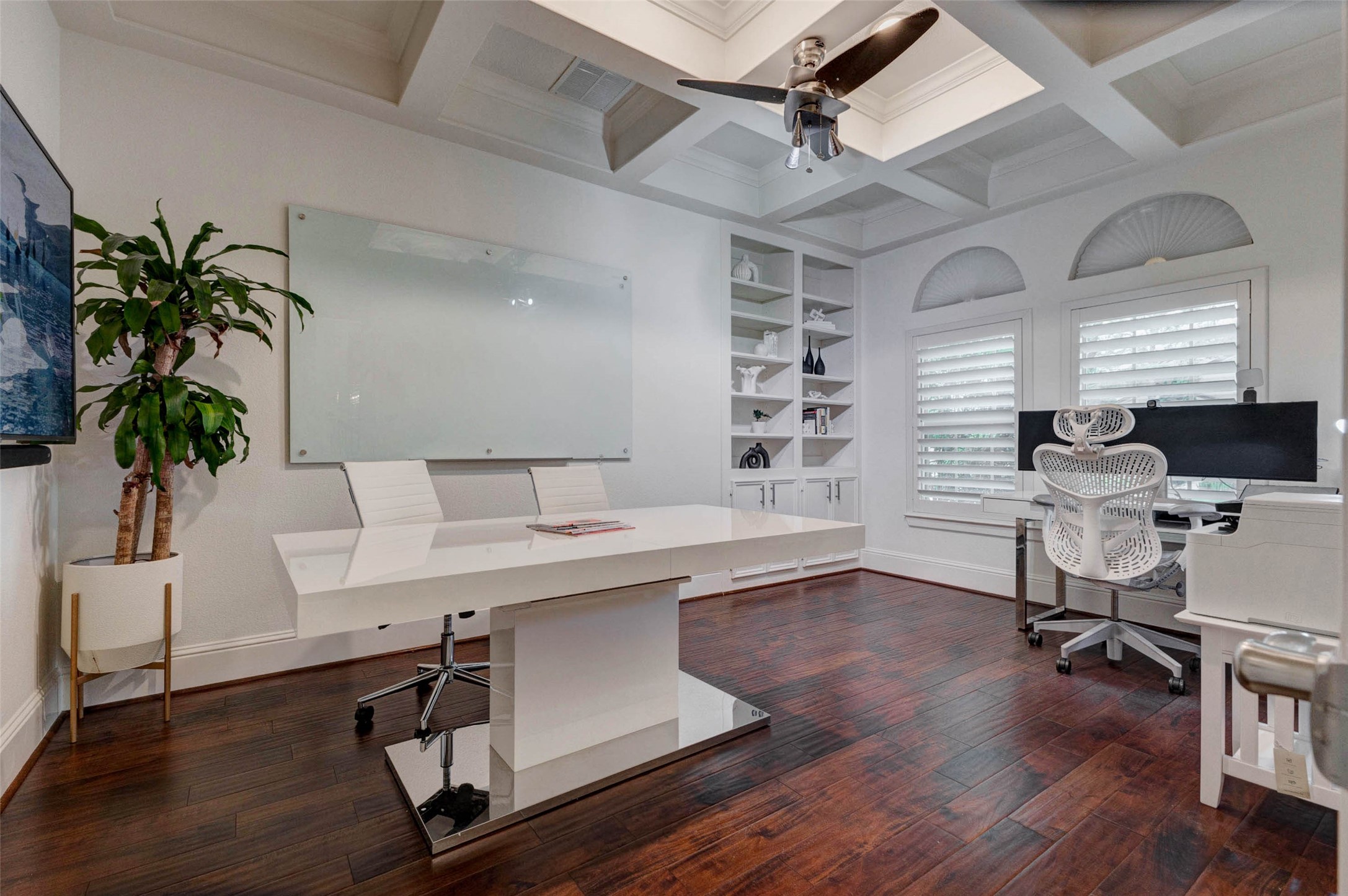 27602 Guthrie Ridge Lane Katy, TX 77494 - Photo 9 of 50 Private office featuring custom built-ins, plantation shutters, and a coffered ceiling for a polished
workspace.