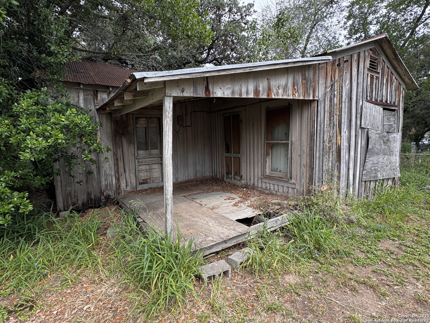 212 Patrick Pleasanton, TX 78064 - Photo 11 of 13 a view of a small house with roof and wooden fence