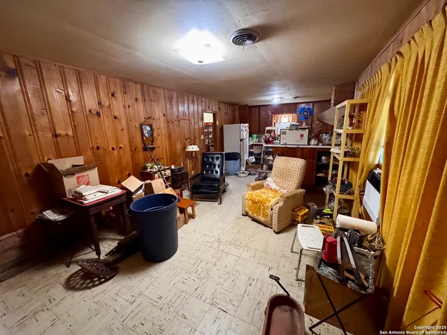 a view of a livingroom with workspace and a window