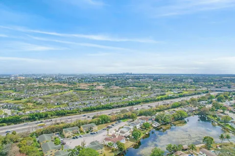 an aerial view of residential houses with outdoor space and trees