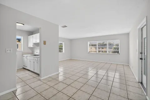 a view of a kitchen with white cabinets and a stove top oven