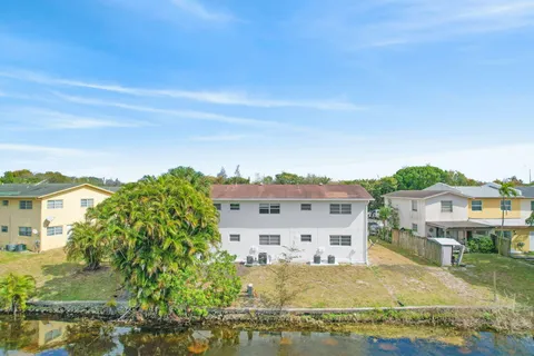 an aerial view of residential houses with yard
