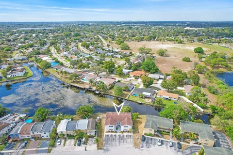 an aerial view of residential building and lake