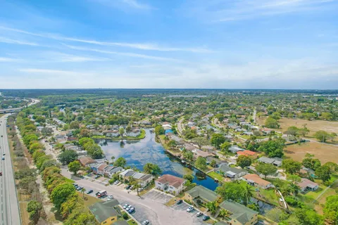 an aerial view of residential building with green space